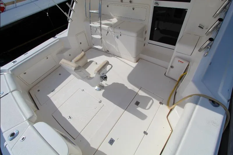  Yacht Photos Pics 2005 Riviera 46 Convertible Sportfisher cockpit with fishing chair and storage compartments.