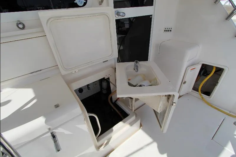  Yacht Photos Pics 2005 Riviera 46 Convertible Sportfisher interior with sink and storage compartments.