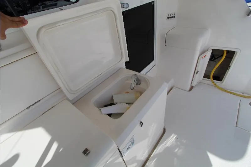  Yacht Photos Pics Open storage compartment on 2005 Riviera 46 Convertible Sportfisher boat deck.