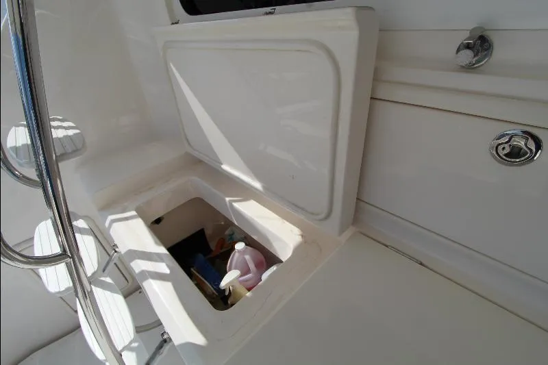  Yacht Photos Pics Open storage compartment on 2005 Riviera 46 Convertible Sportfisher boat, containing cleaning supplies.