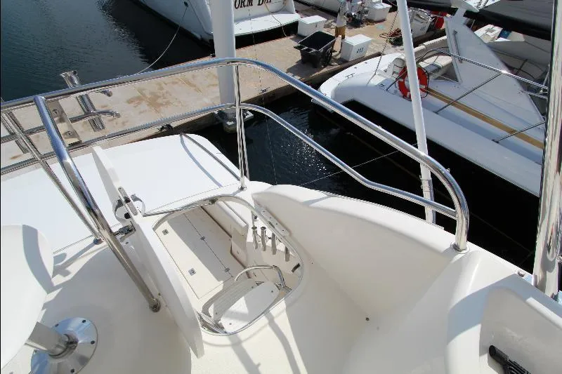  Yacht Photos Pics 2005 Riviera 46 Convertible Sportfisher yacht deck with railing and marina view.