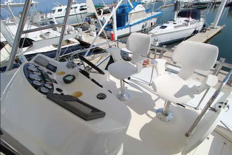  Yacht Photos Pics Helm of 2005 Riviera 46 Convertible Sportfisher with dual seats and control panel at marina.