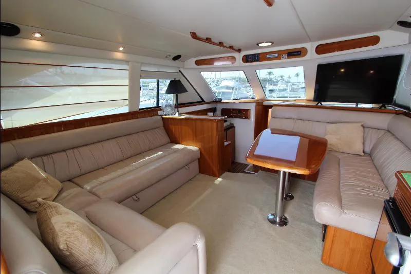  Yacht Photos Pics Luxurious interior of 2005 Riviera 46 Convertible Sportfisher with plush seating and wooden accents.