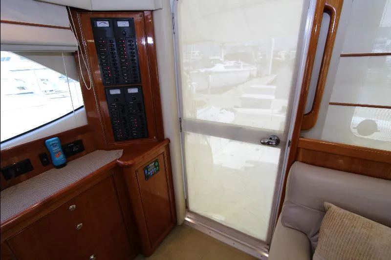  Yacht Photos Pics Interior of 2005 Riviera 46 Convertible Sportfisher with control panels and seating area.