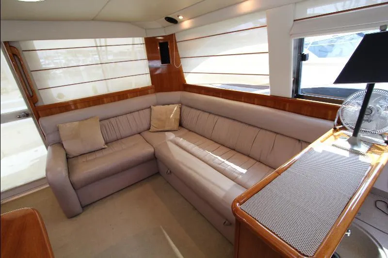  Yacht Photos Pics Luxurious interior of 2005 Riviera 46 Convertible Sportfisher with plush seating and elegant decor.