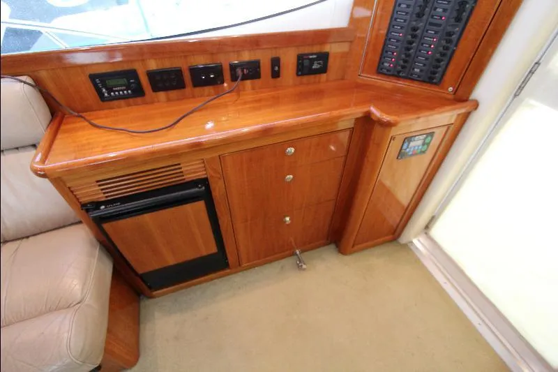  Yacht Photos Pics 2005 Riviera 46 Convertible Sportfisher interior with wooden cabinetry and control panel.