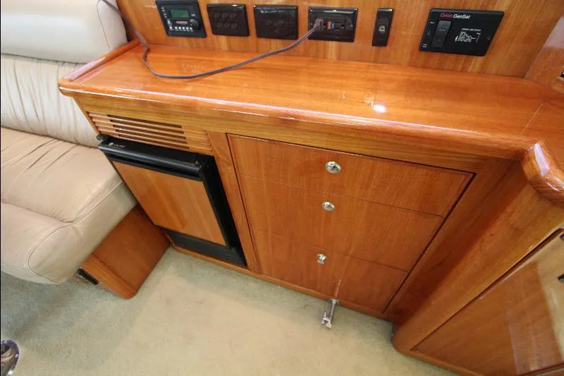  Yacht Photos Pics 2005 Riviera 46 Convertible Sportfisher interior with wooden cabinetry and control panels.