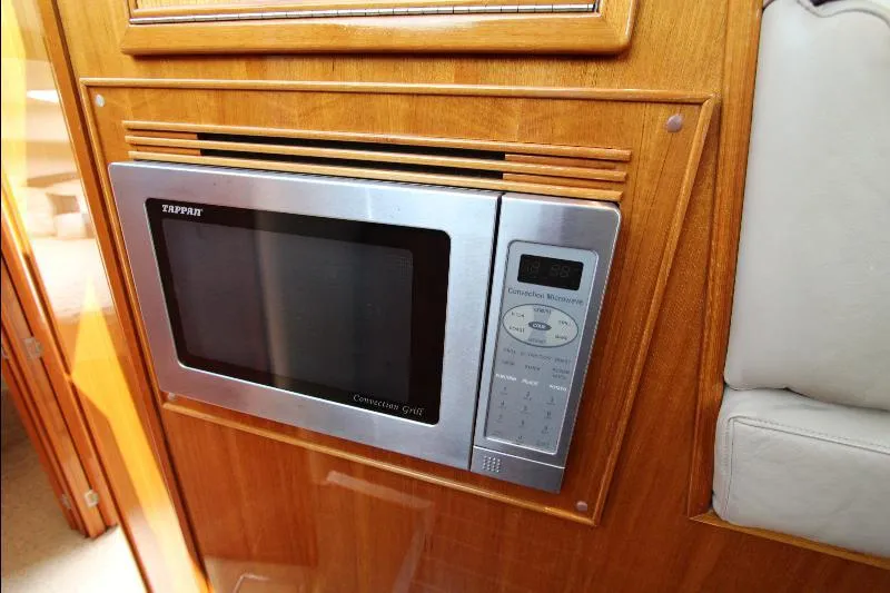  Yacht Photos Pics Built-in microwave in 2005 Riviera 46 Convertible Sportfisher yacht kitchen.