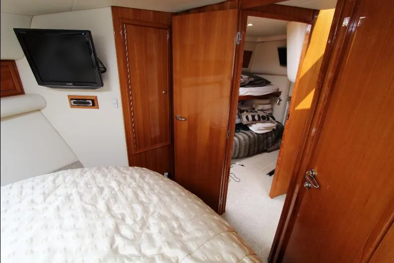  Yacht Photos Pics Interior of 2005 Riviera 46 Convertible Sportfisher with wood paneling and cozy sleeping quarters.