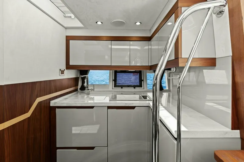 Board Room Yacht Photos Pics Modern kitchen interior on 2017 Galeon 385 HTS yacht, featuring sleek cabinetry and ocean view.