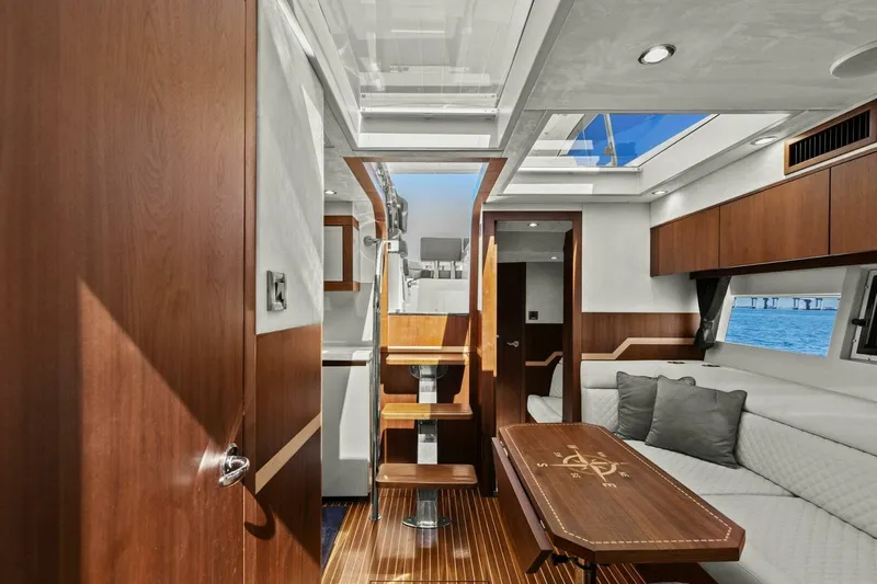 Board Room Yacht Photos Pics Luxurious interior of 2017 Galeon 385 HTS yacht with wooden finishes and elegant seating.