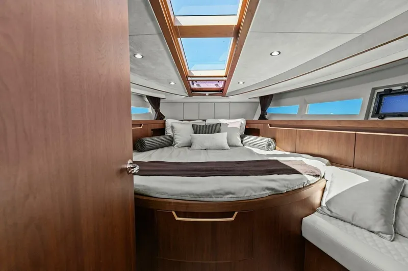 Board Room Yacht Photos Pics Luxurious cabin interior of 2017 Galeon 385 HTS yacht with skylight and elegant bedding.