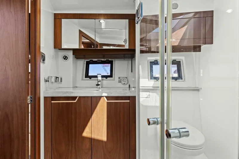 Board Room Yacht Photos Pics Luxurious bathroom interior of 2017 Galeon 385 HTS yacht with wood accents and modern fixtures.