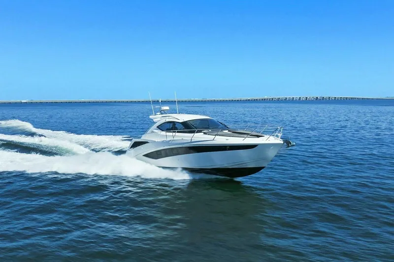 Board Room Yacht Photos Pics 2017 Galeon 385 HTS yacht cruising on open water under clear blue skies.