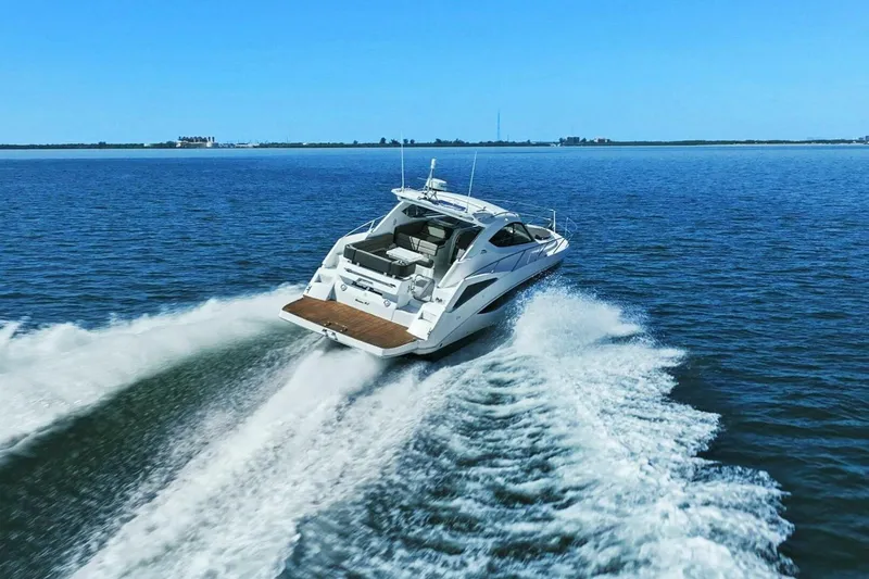 Board Room Yacht Photos Pics 2017 Galeon 385 HTS yacht cruising on open water, leaving a wake behind.