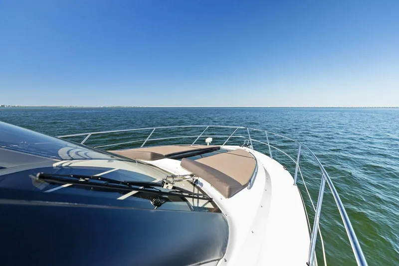 Board Room Yacht Photos Pics 2017 Galeon 385 HTS yacht cruising on open water under clear blue sky.