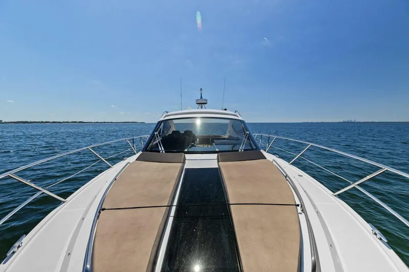 Board Room Yacht Photos Pics 2017 Galeon 385 HTS yacht cruising on open water under clear blue sky.