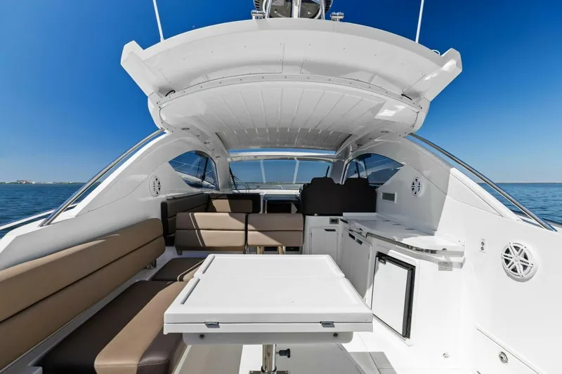 Board Room Yacht Photos Pics Luxurious 2017 Galeon 385 HTS yacht interior with seating and table, overlooking the ocean.