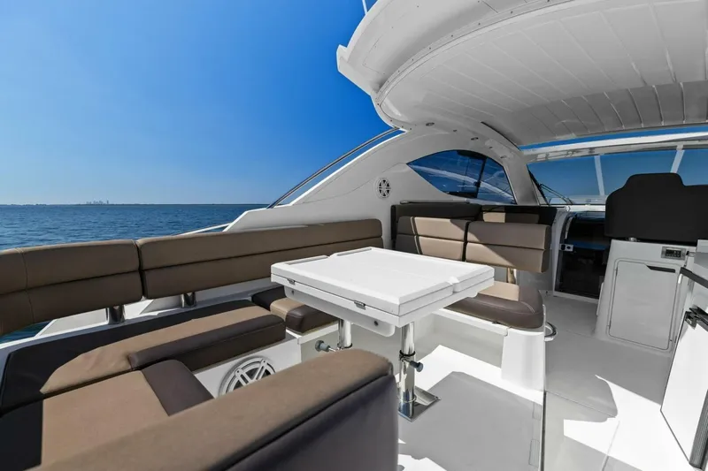 Board Room Yacht Photos Pics Luxurious 2017 Galeon 385 HTS yacht interior with seating and table, overlooking the ocean.