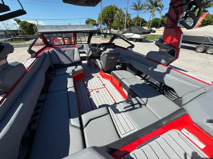  Yacht Photos Pics 2025 Nautique Super Air Nautique G23 interior with gray seating and red accents.