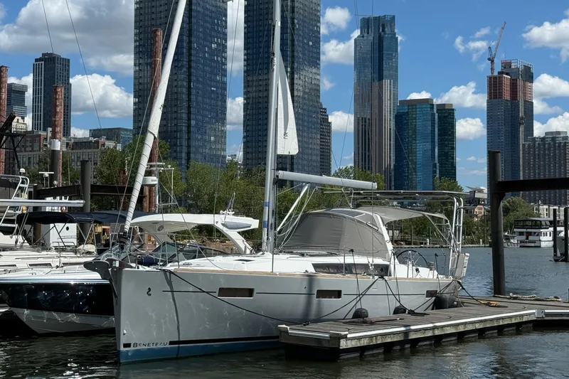 Wind Waker Yacht Photos Pics 2013 Beneteau Oceanis 41 sailboat docked in urban marina with skyscrapers in background.