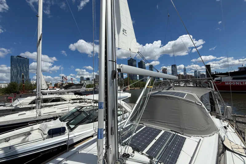 Wind Waker Yacht Photos Pics 2013 Beneteau Oceanis 41 sailboat docked in urban marina, city skyline in background.