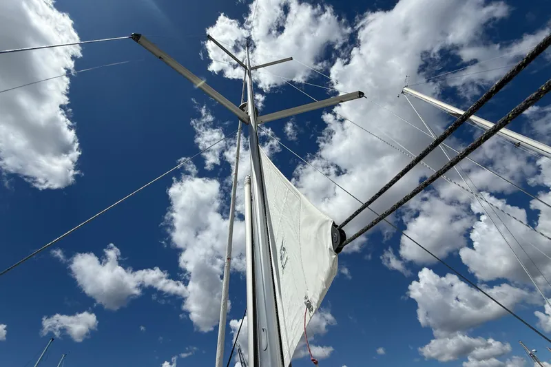 Wind Waker Yacht Photos Pics Sailboat mast and rigging of 2013 Beneteau Oceanis 41 against a cloudy blue sky.