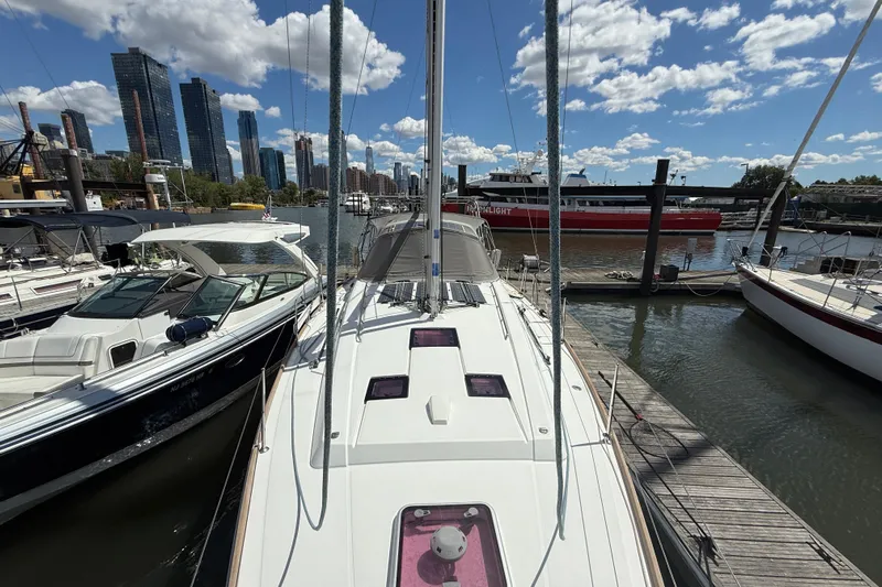 Wind Waker Yacht Photos Pics 2013 Beneteau Oceanis 41 sailboat docked in urban marina with city skyline.