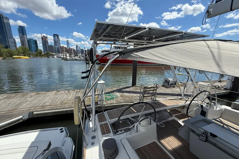 Wind Waker Yacht Photos Pics Beneteau Oceanis 41 sailboat docked at marina, city skyline in background, sunny day.
