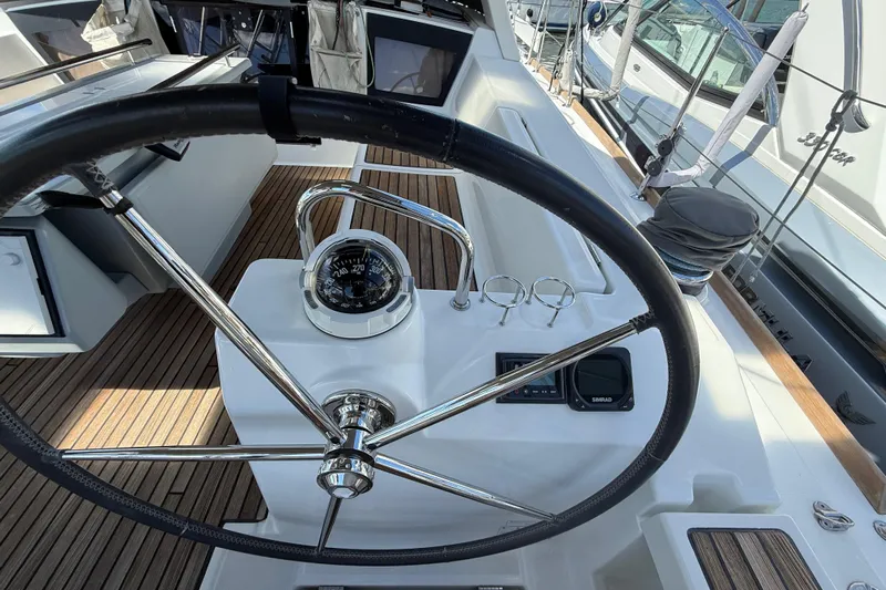 Wind Waker Yacht Photos Pics Steering wheel and compass on 2013 Beneteau Oceanis 41 yacht deck.