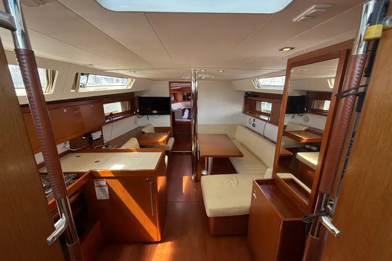 Wind Waker Yacht Photos Pics Interior of 2013 Beneteau Oceanis 41 yacht with modern wood finish and seating area.