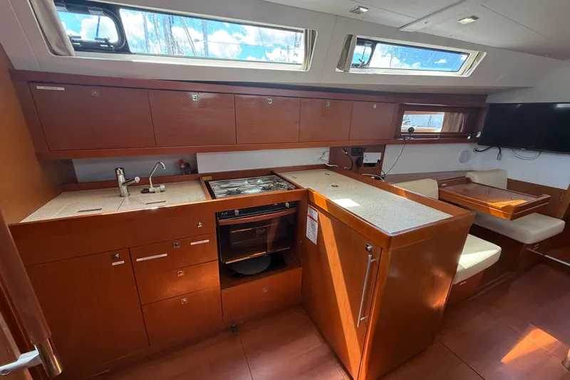 Wind Waker Yacht Photos Pics Interior of 2013 Beneteau Oceanis 41 yacht, featuring a modern kitchen and dining area.