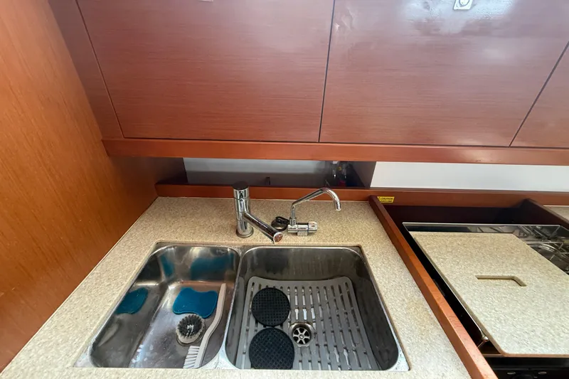 Wind Waker Yacht Photos Pics Galley sink area in 2013 Beneteau Oceanis 41 yacht with wooden cabinetry.