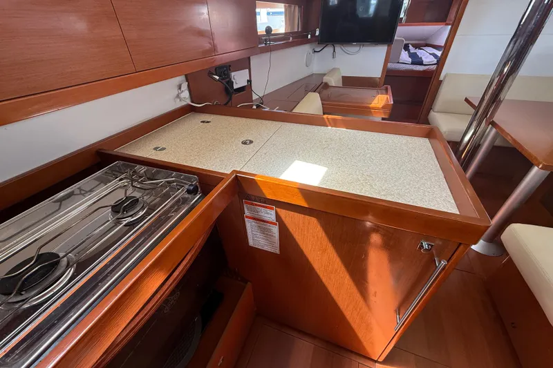 Wind Waker Yacht Photos Pics Interior of 2013 Beneteau Oceanis 41 yacht kitchen with stove and seating area.
