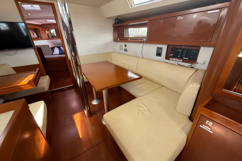 Wind Waker Yacht Photos Pics Interior of 2013 Beneteau Oceanis 41 yacht with wooden furnishings and cream seating.
