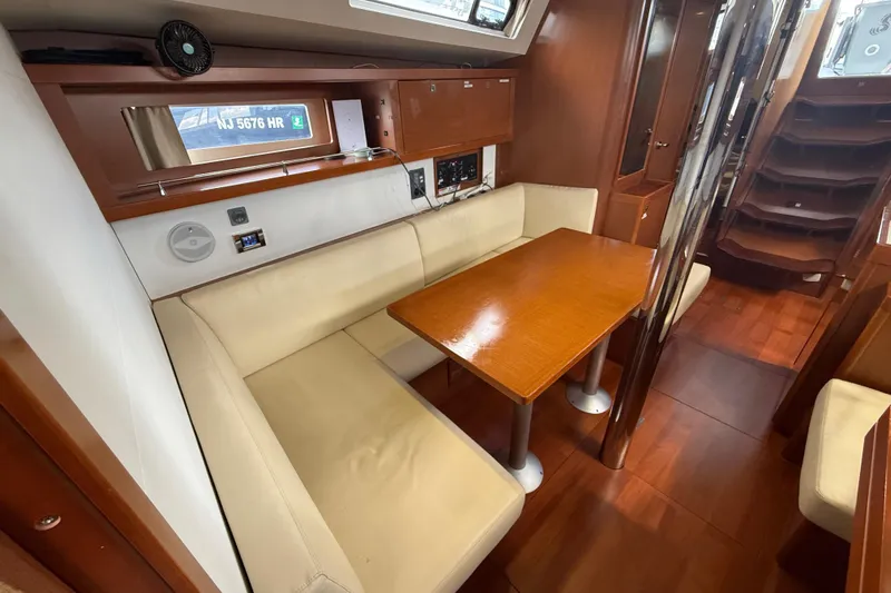 Wind Waker Yacht Photos Pics Interior of 2013 Beneteau Oceanis 41 sailboat with cozy dining area and wooden finishes.