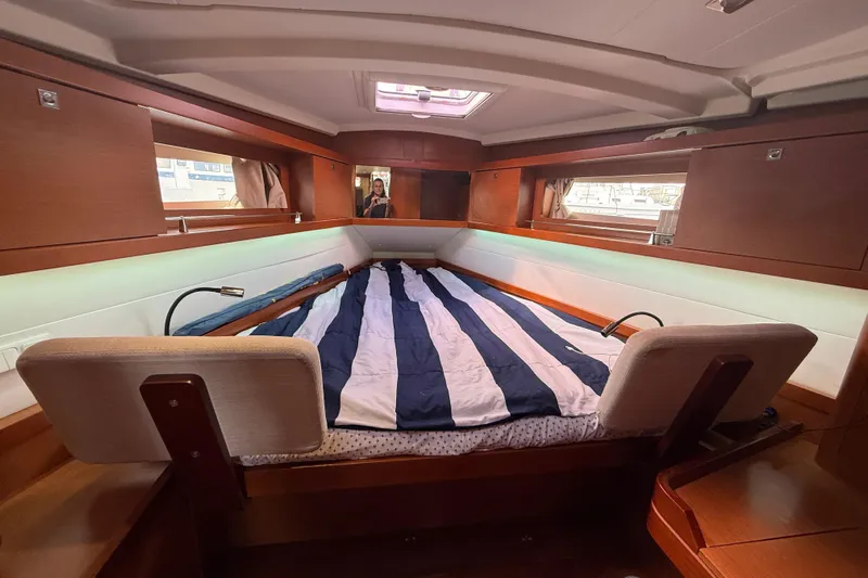 Wind Waker Yacht Photos Pics Cozy cabin interior of 2013 Beneteau Oceanis 41 sailboat with striped bedding.
