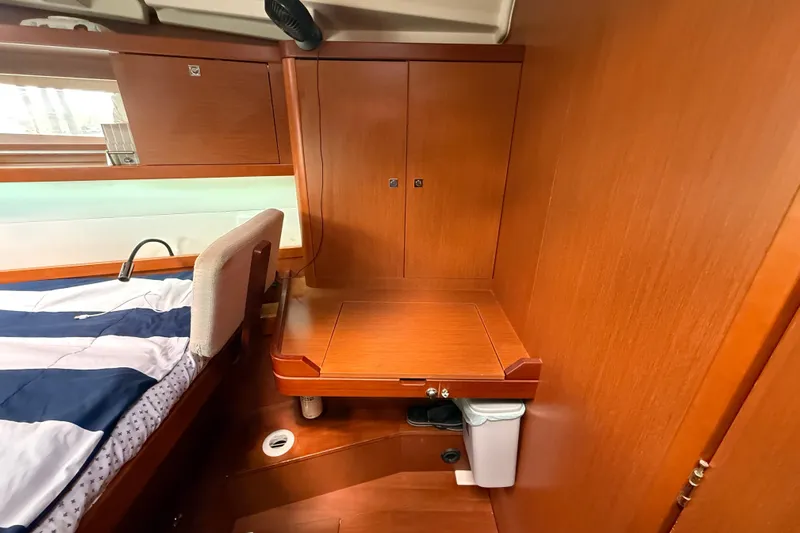 Wind Waker Yacht Photos Pics Interior cabin of 2013 Beneteau Oceanis 41 yacht with wooden cabinetry and bed.