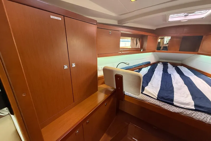 Wind Waker Yacht Photos Pics Luxurious cabin interior of 2013 Beneteau Oceanis 41 sailboat with striped bedding.