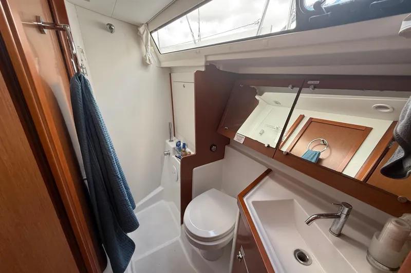 Wind Waker Yacht Photos Pics Bathroom interior of 2013 Beneteau Oceanis 41 yacht, featuring sink, toilet, and mirror.