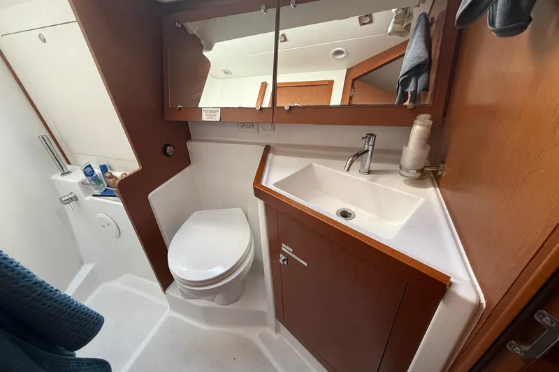 Wind Waker Yacht Photos Pics Bathroom interior of 2013 Beneteau Oceanis 41 yacht with sink, toilet, and mirror.