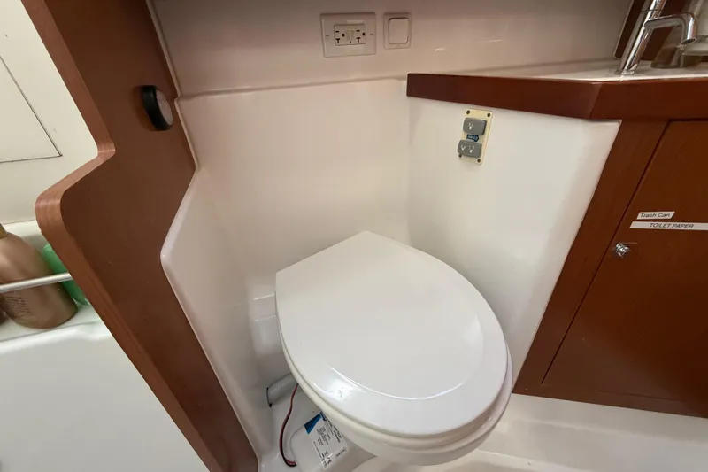 Wind Waker Yacht Photos Pics Beneteau Oceanis 41 (2013) yacht bathroom with toilet and wooden cabinetry.