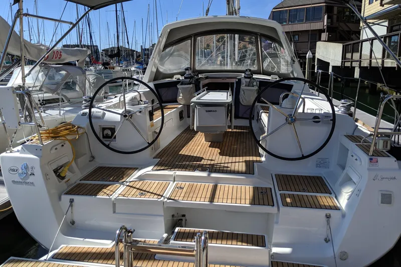 Wind Waker Yacht Photos Pics 2013 Beneteau Oceanis 41 sailboat with dual steering wheels and teak deck in marina.