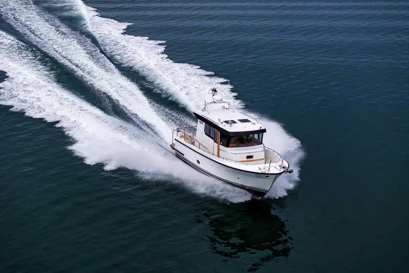  Yacht Photos Pics 2024 Targa 30.1 boat cruising on open water, leaving a wake behind.