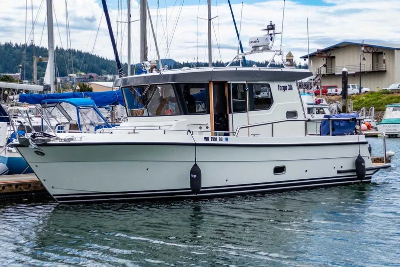  Yacht Photos Pics 2024 Targa 30.1 boat docked at a marina with scenic background.
