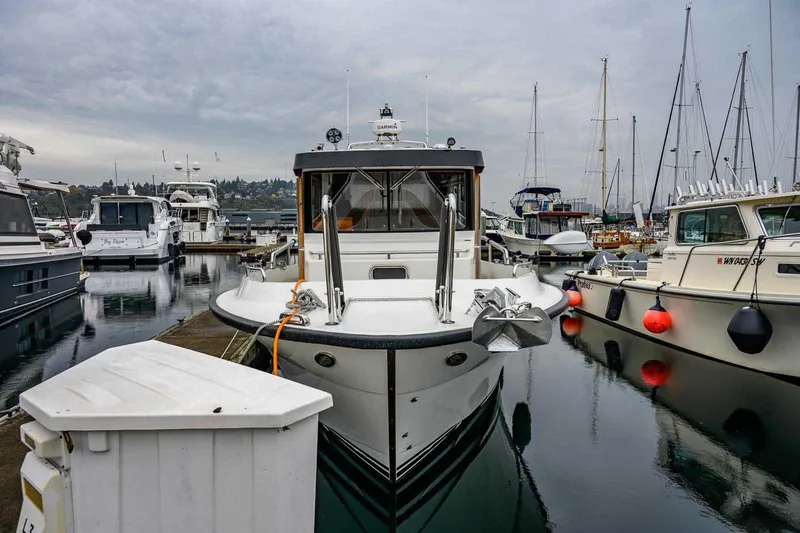  Yacht Photos Pics 2024 Targa 30.1 boat docked in a marina, surrounded by other vessels.