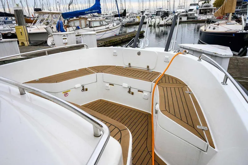  Yacht Photos Pics 2024 Targa 30.1 boat with teak deck, docked in a marina.