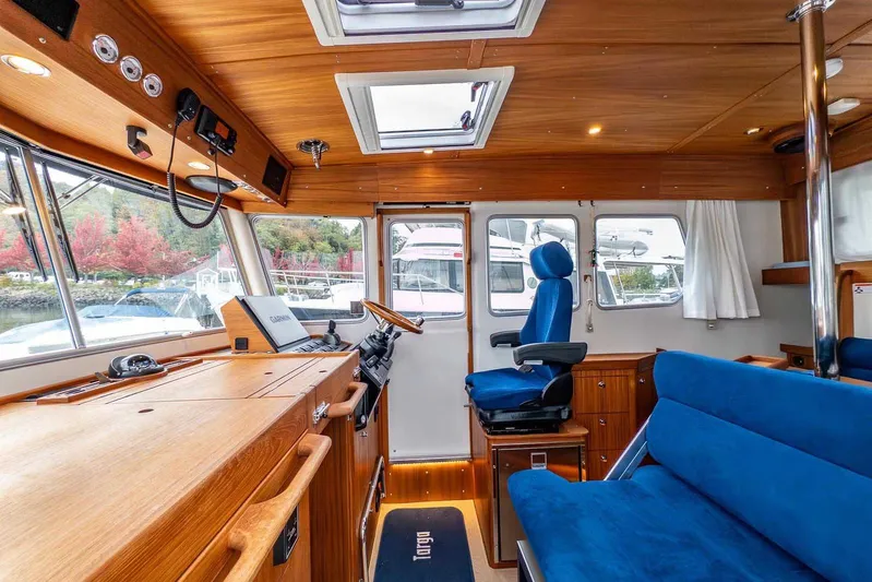  Yacht Photos Pics Interior of 2024 Targa 30.1 boat with wooden finish and blue seating.