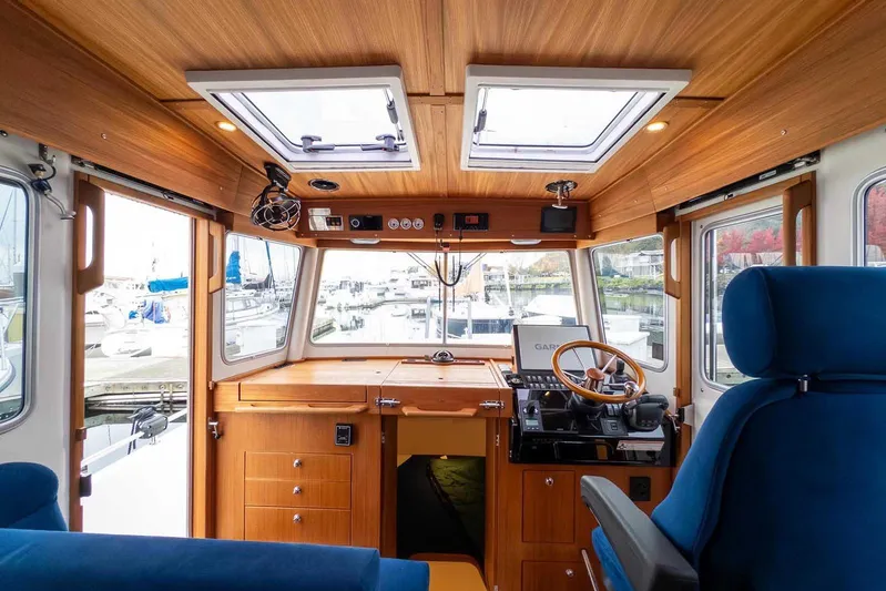  Yacht Photos Pics Interior of 2024 Targa 30.1 boat with wooden finish and modern navigation equipment.