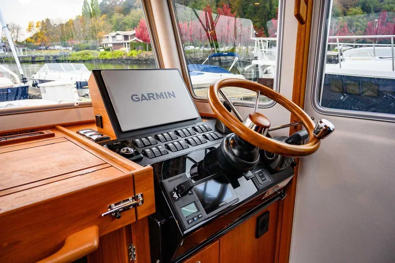  Yacht Photos Pics 2024 Targa 30.1 boat helm with Garmin navigation system and wooden steering wheel.